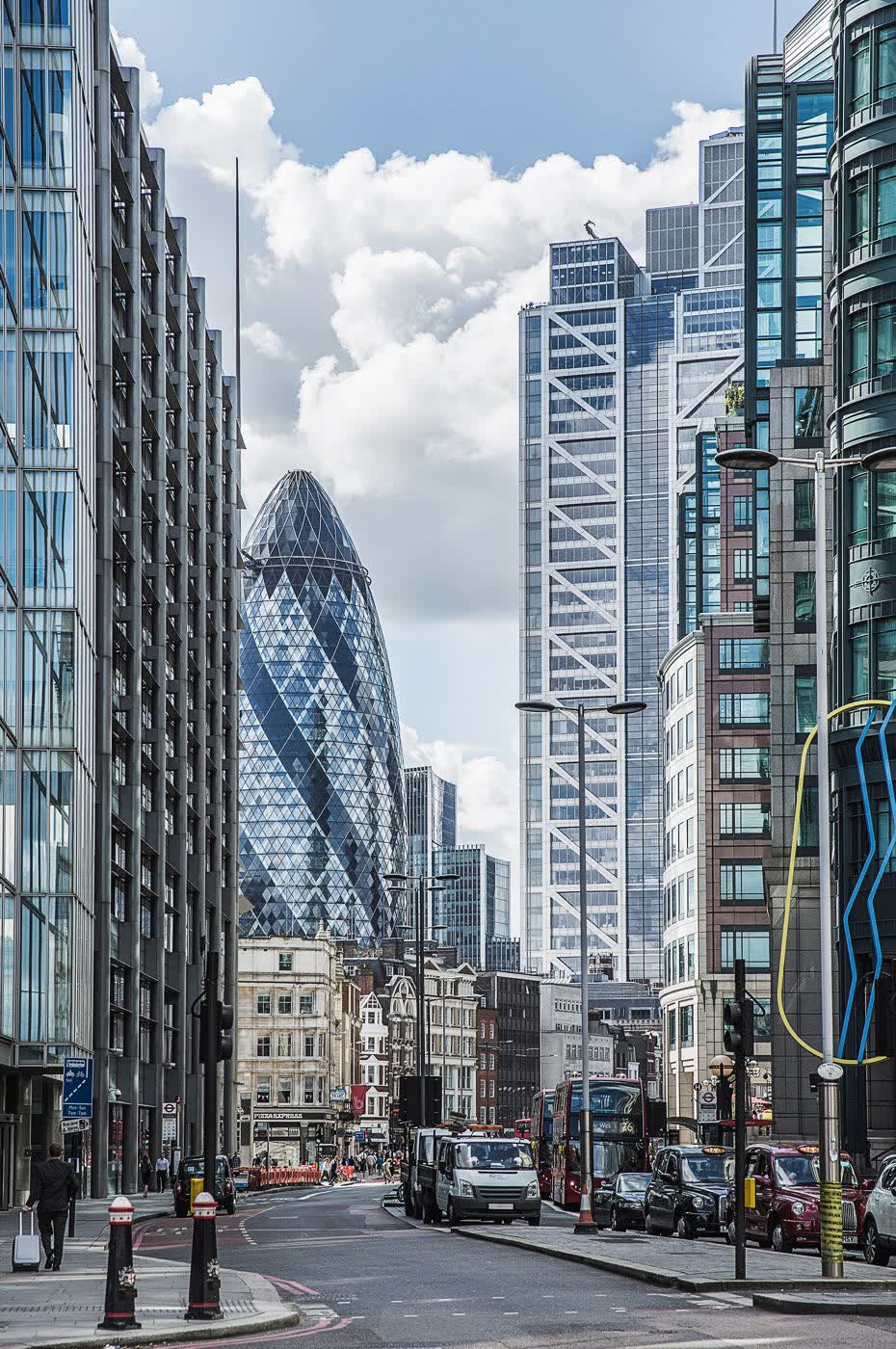 Historic stone facade beside modern glass towers in the City of London